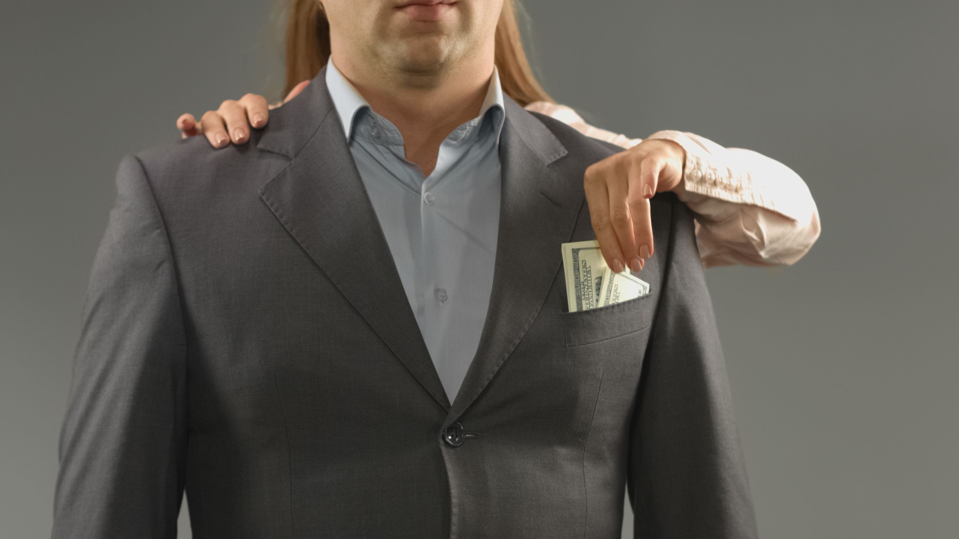 Cunning girlfriend taking cash money from mans pocket, marriage contract, fraud